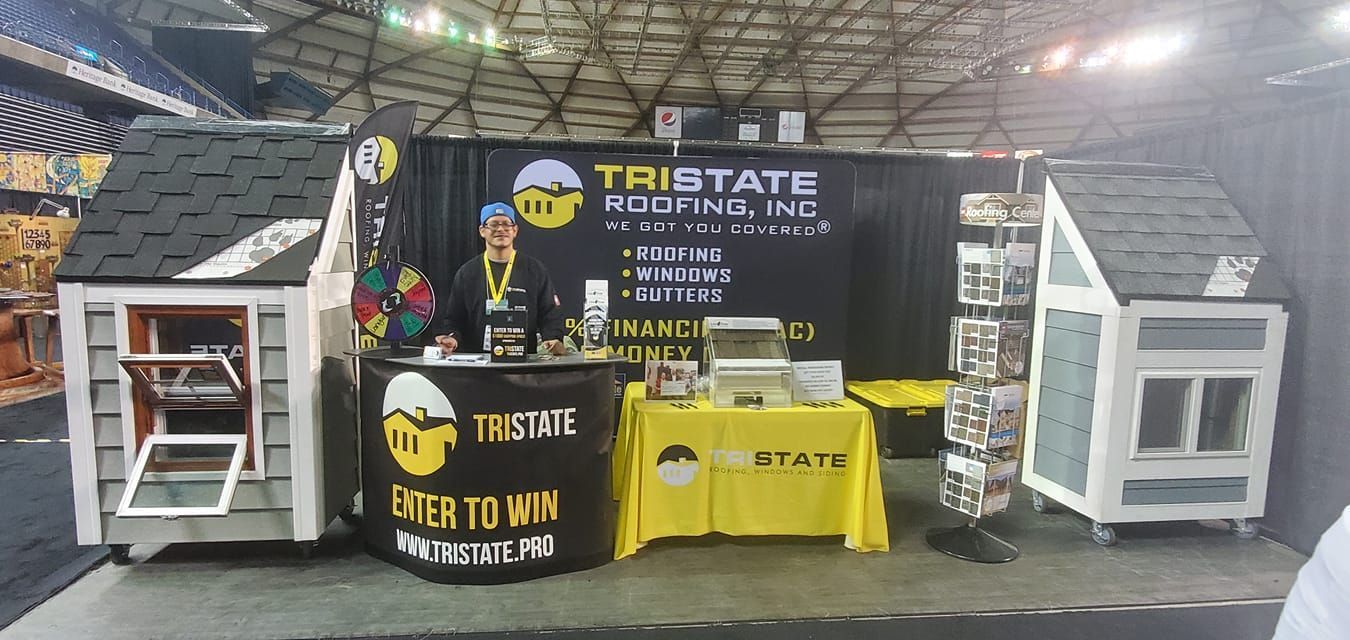 A booth with a sign that says this state roofing inc