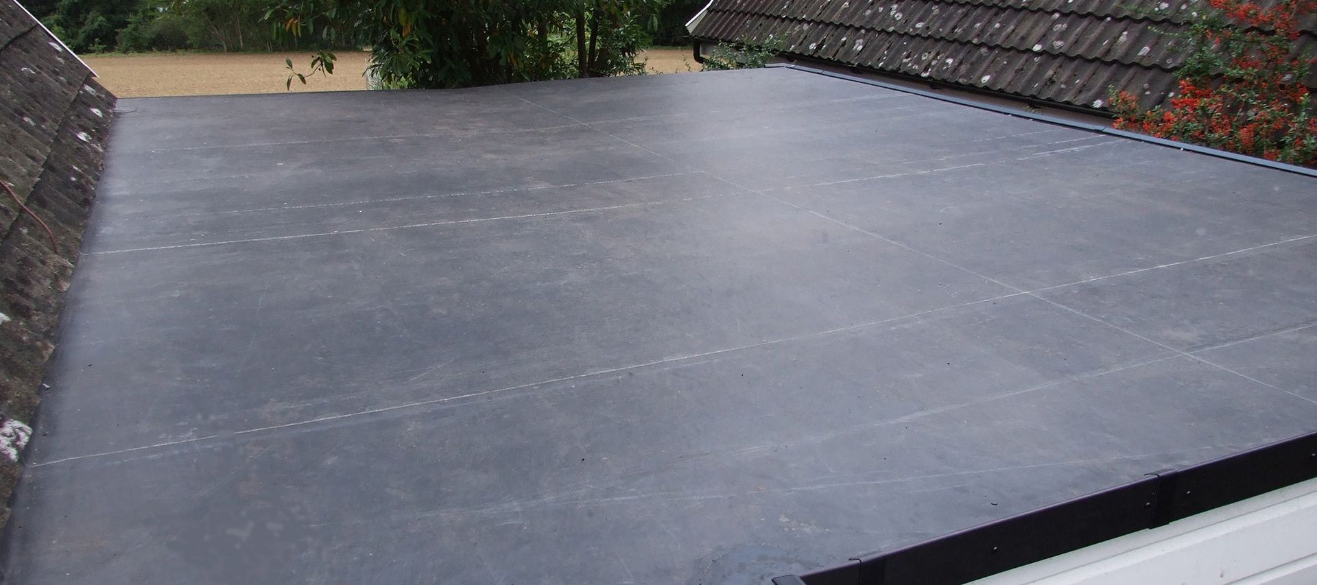 Completed flat roof with smooth, seamless EPDM rubber membrane.