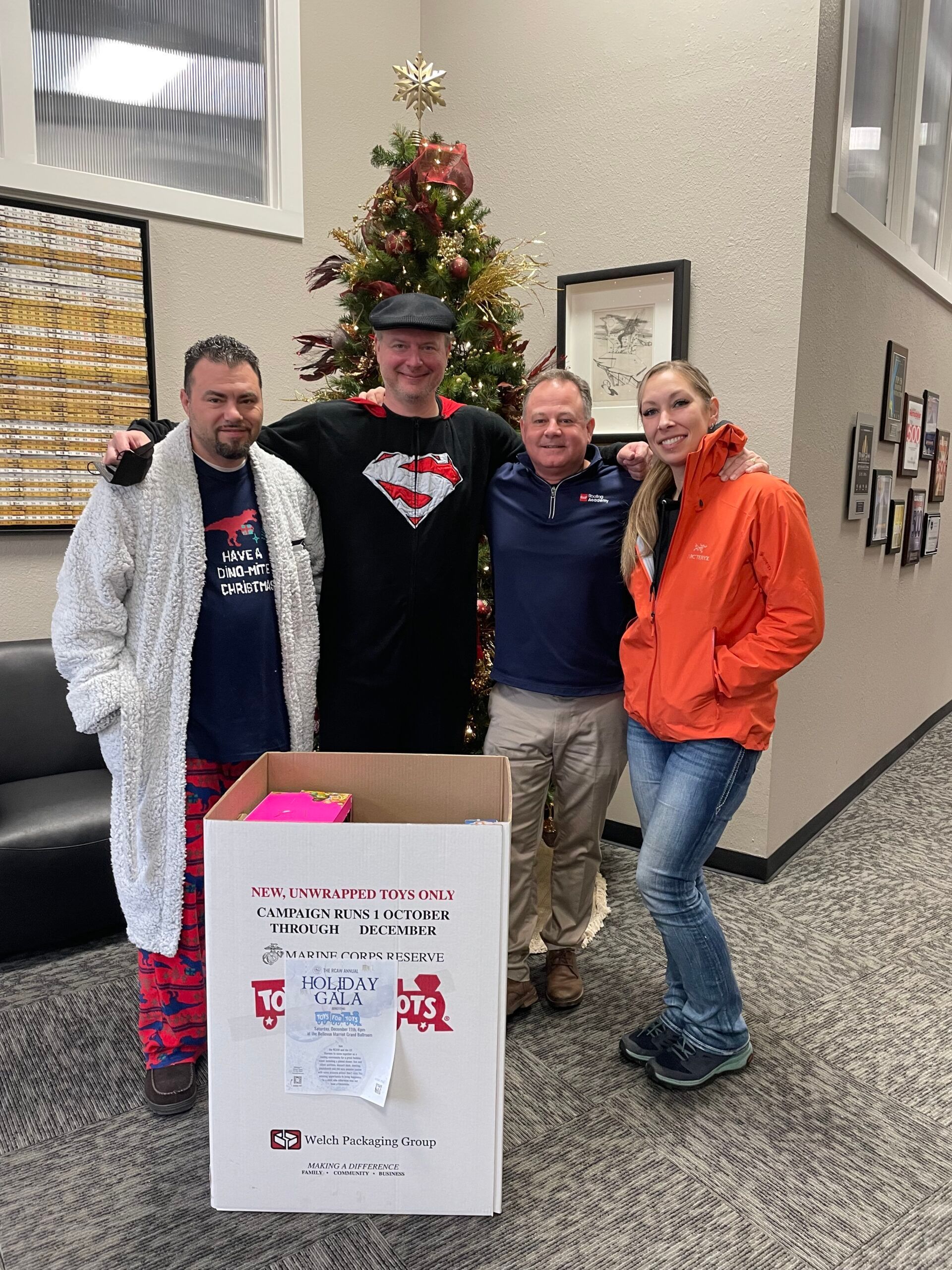 A group of people are posing for a picture in front of a christmas tree.