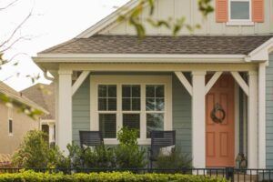A house with a porch and a red door