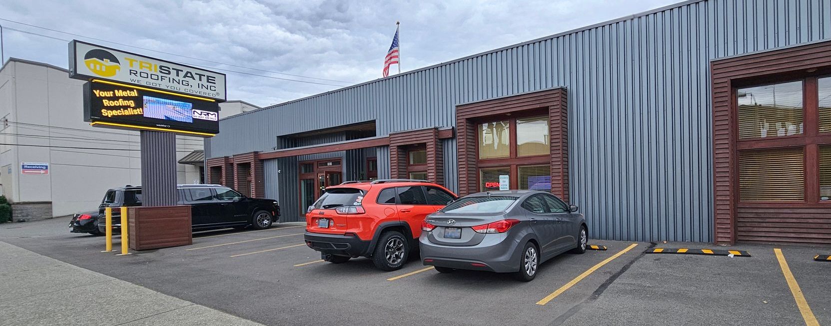 Exterior view of Tristate Roofing’s Tacoma office with company signage.