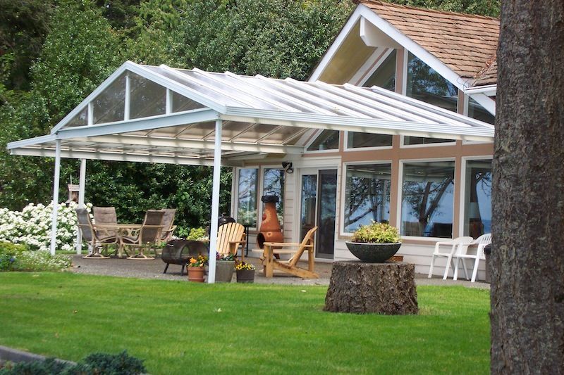 A house with a clear roof and a patio area