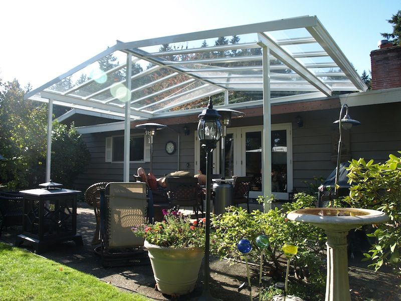 A patio with a clear roof and a bird bath