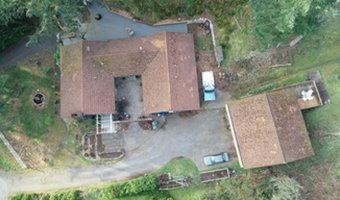 An aerial view of a house with a car parked in front of it.