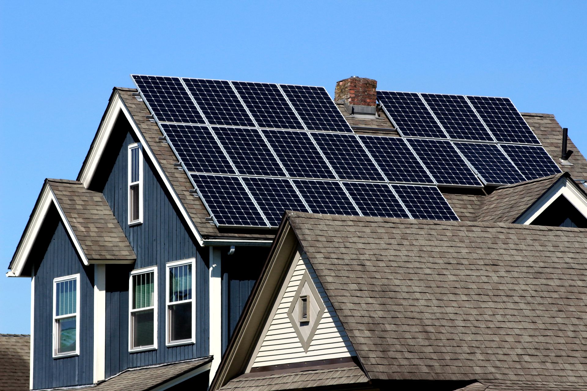 A house with a lot of solar panels on the roof