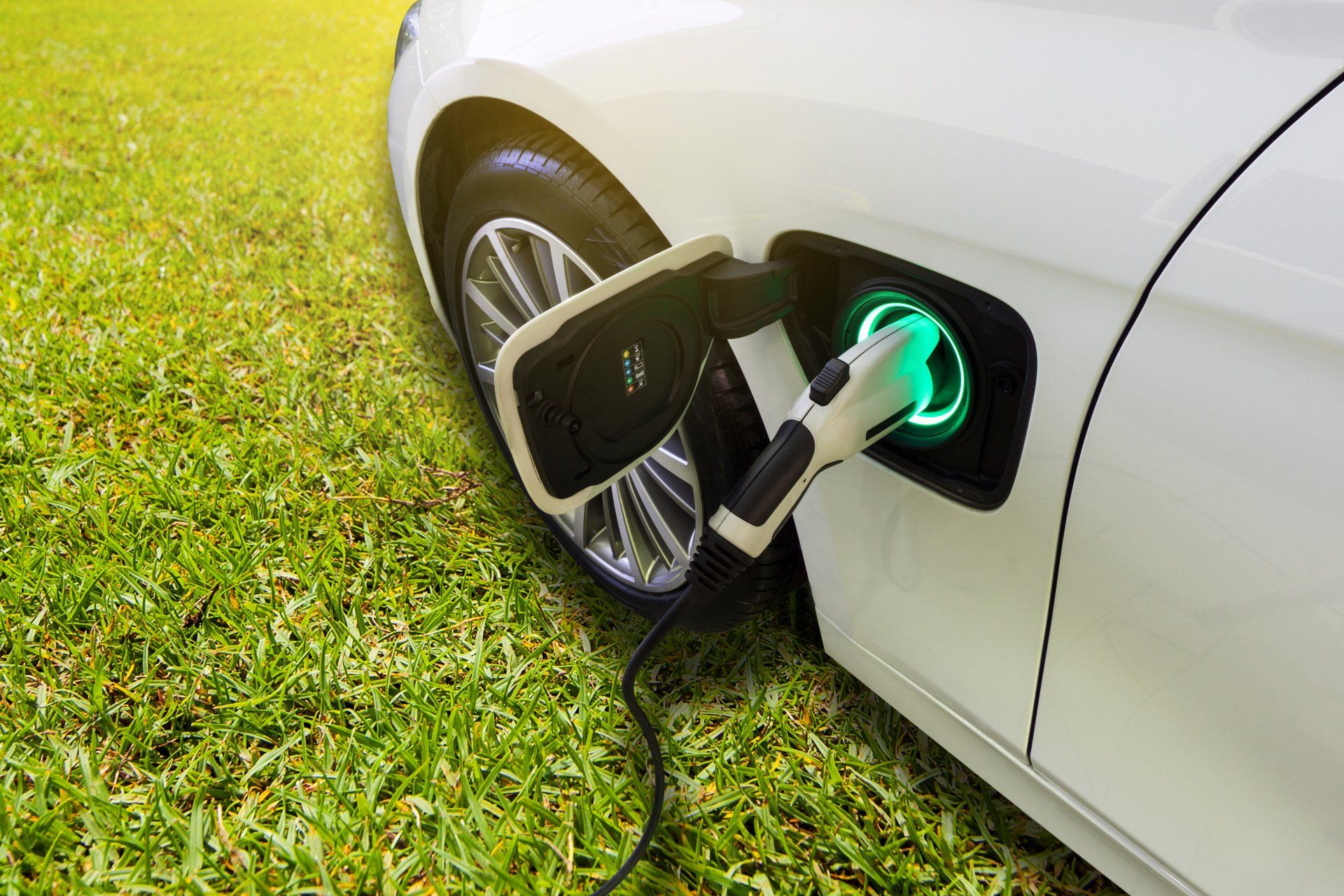 a white electric vehicle being charged