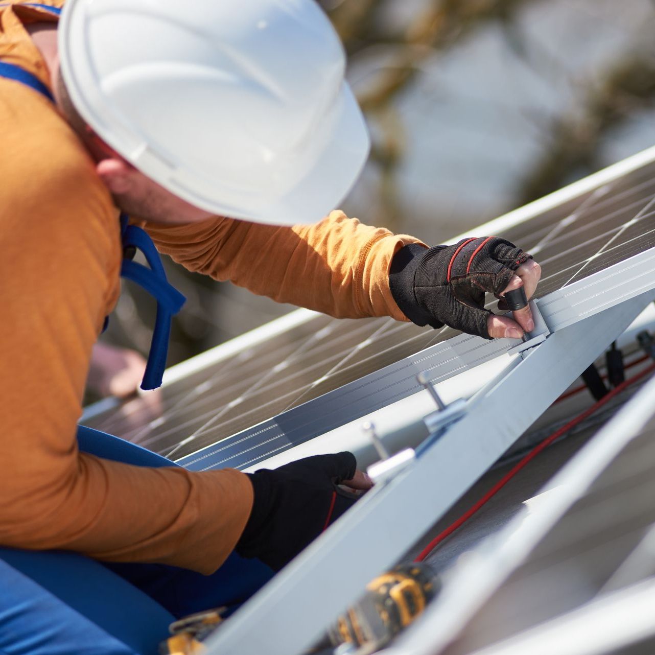 technician installing solar panel