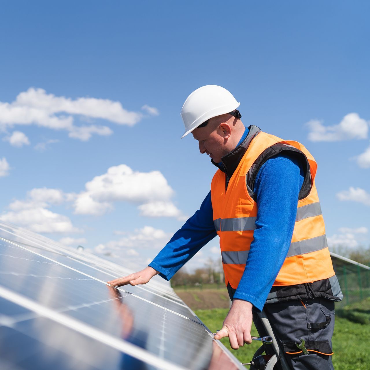 solar technician inspecting solar panel