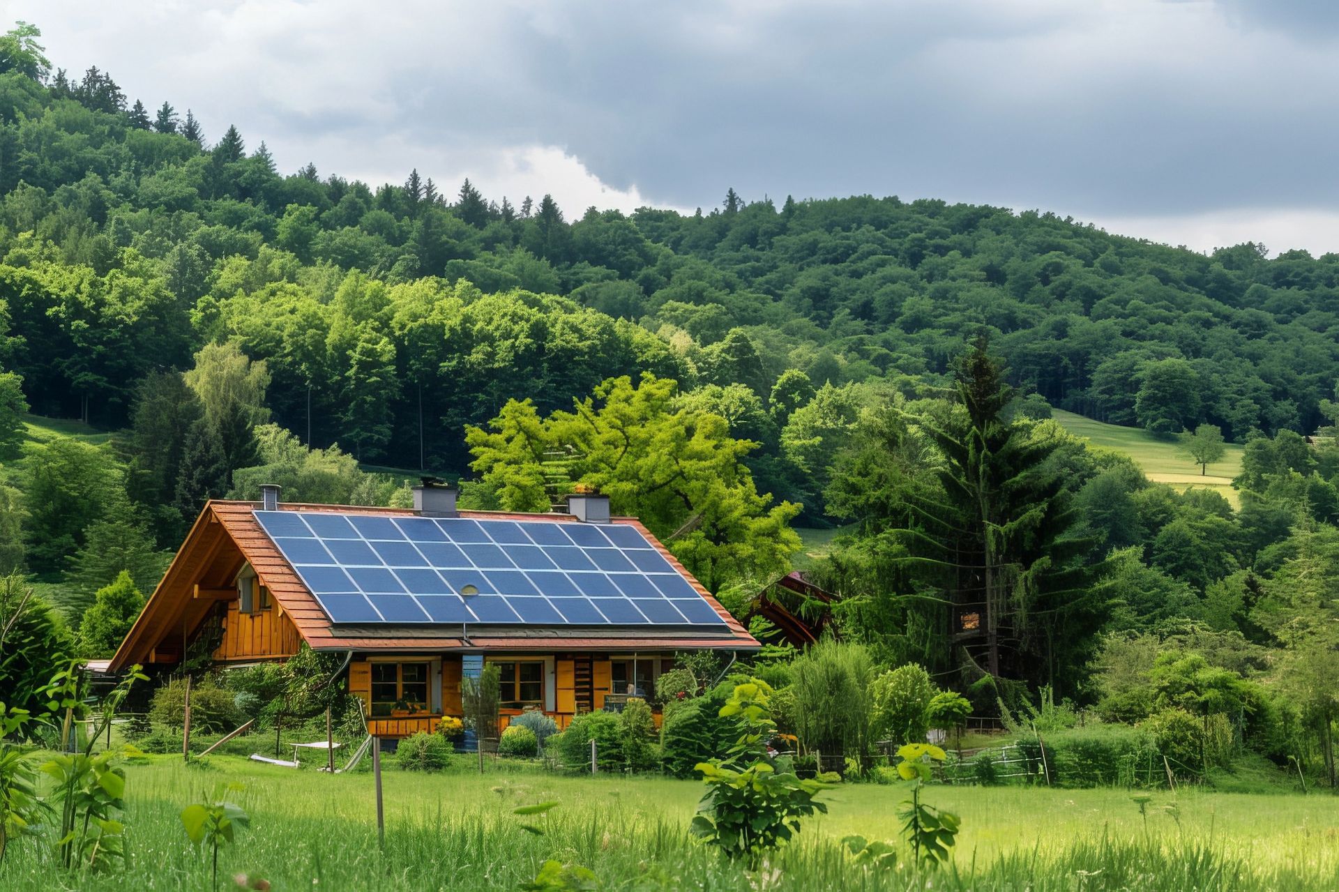 A house with solar panels on the roof is surrounded by trees and grass.