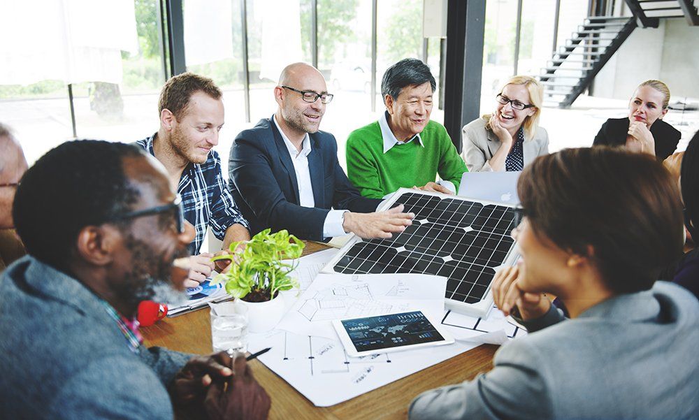 a group of professionals talking about a solar project