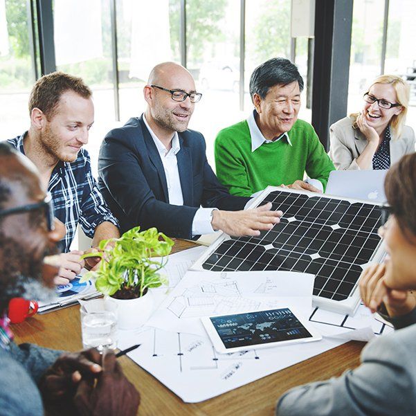 a group of people discussing a solar project