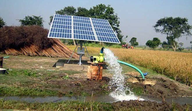 A solar panel is being used to pump water from a well in a field.