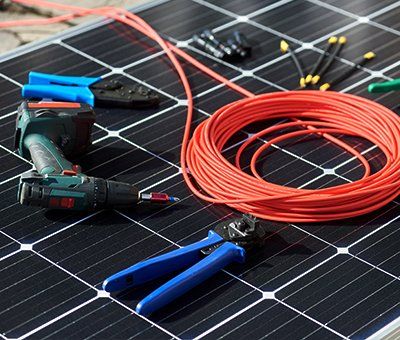 A solar panel with tools and wires on it.