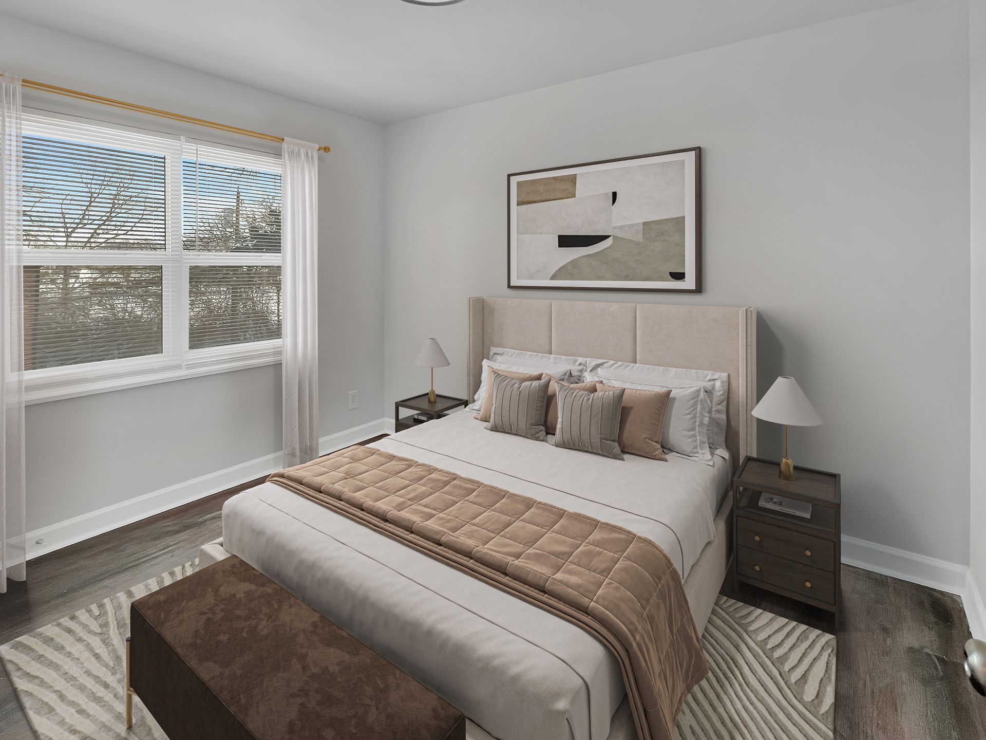 Bedroom with a bed, nightstands, window, and abstract art; neutral colors.