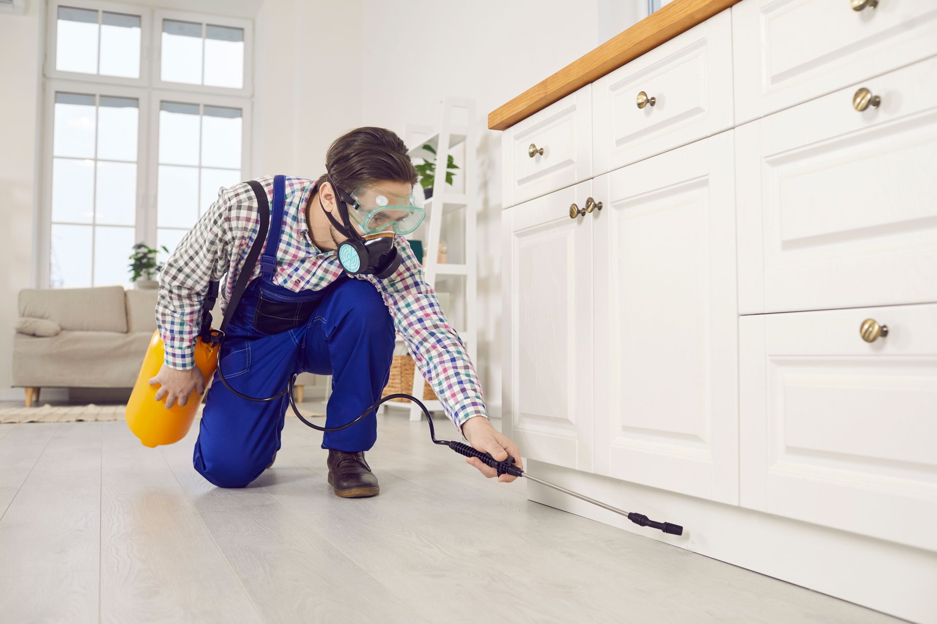 A man is spraying pesticide. A man is spraying pesticide.