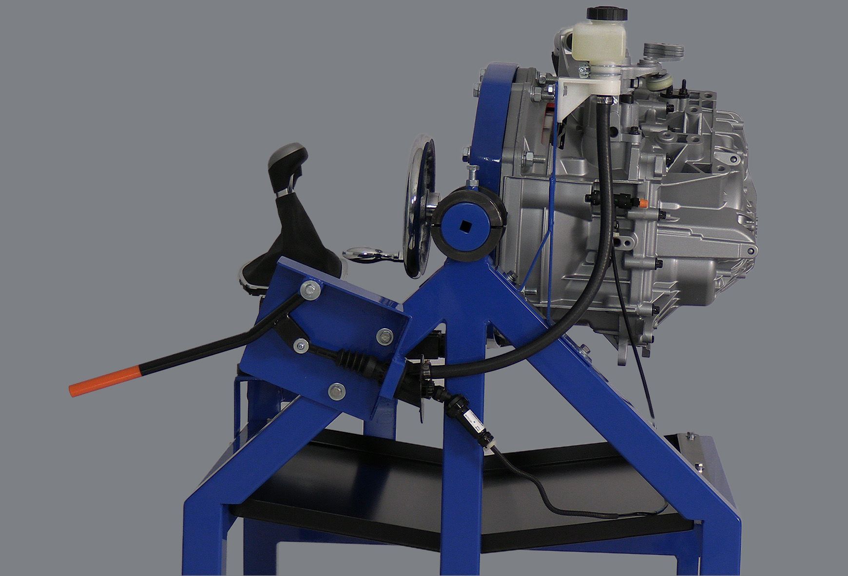 A blue machine is sitting on a table with a gray background.