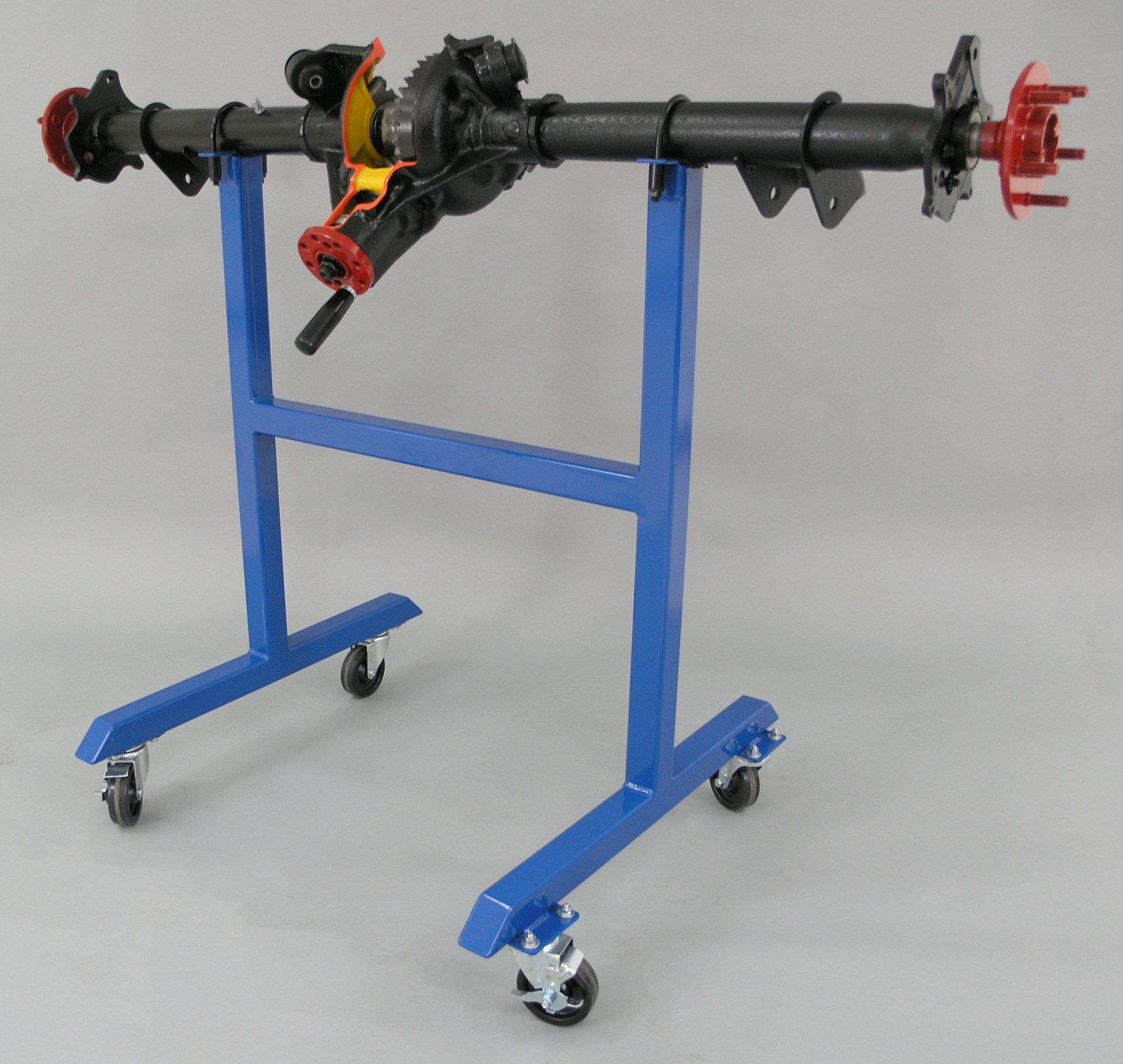 A blue stand with wheels has a black axle on it
