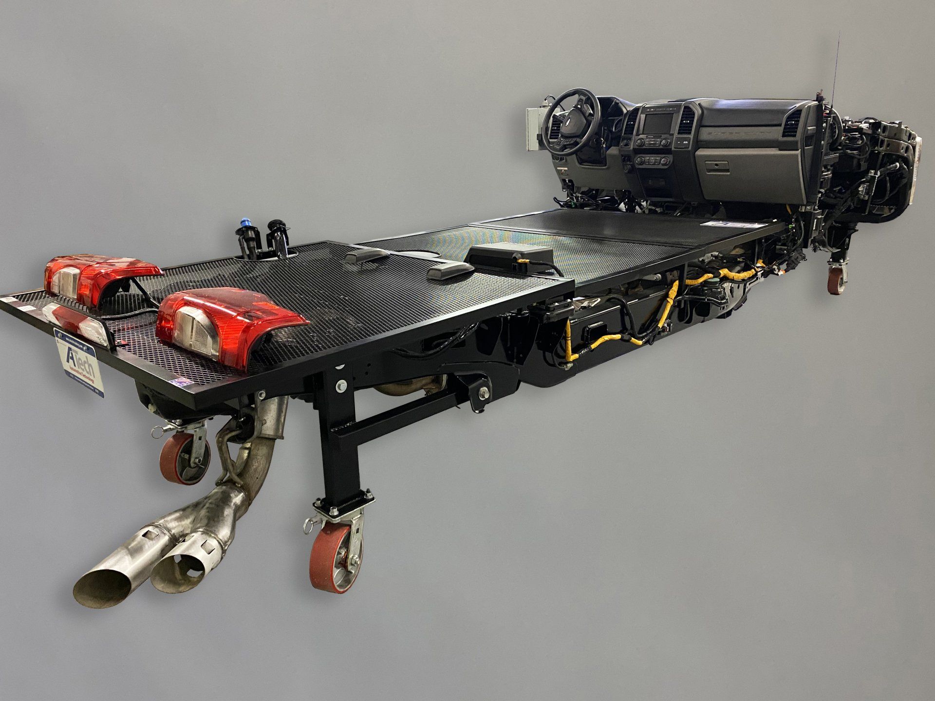 A motorcycle is sitting on top of a table with wheels.