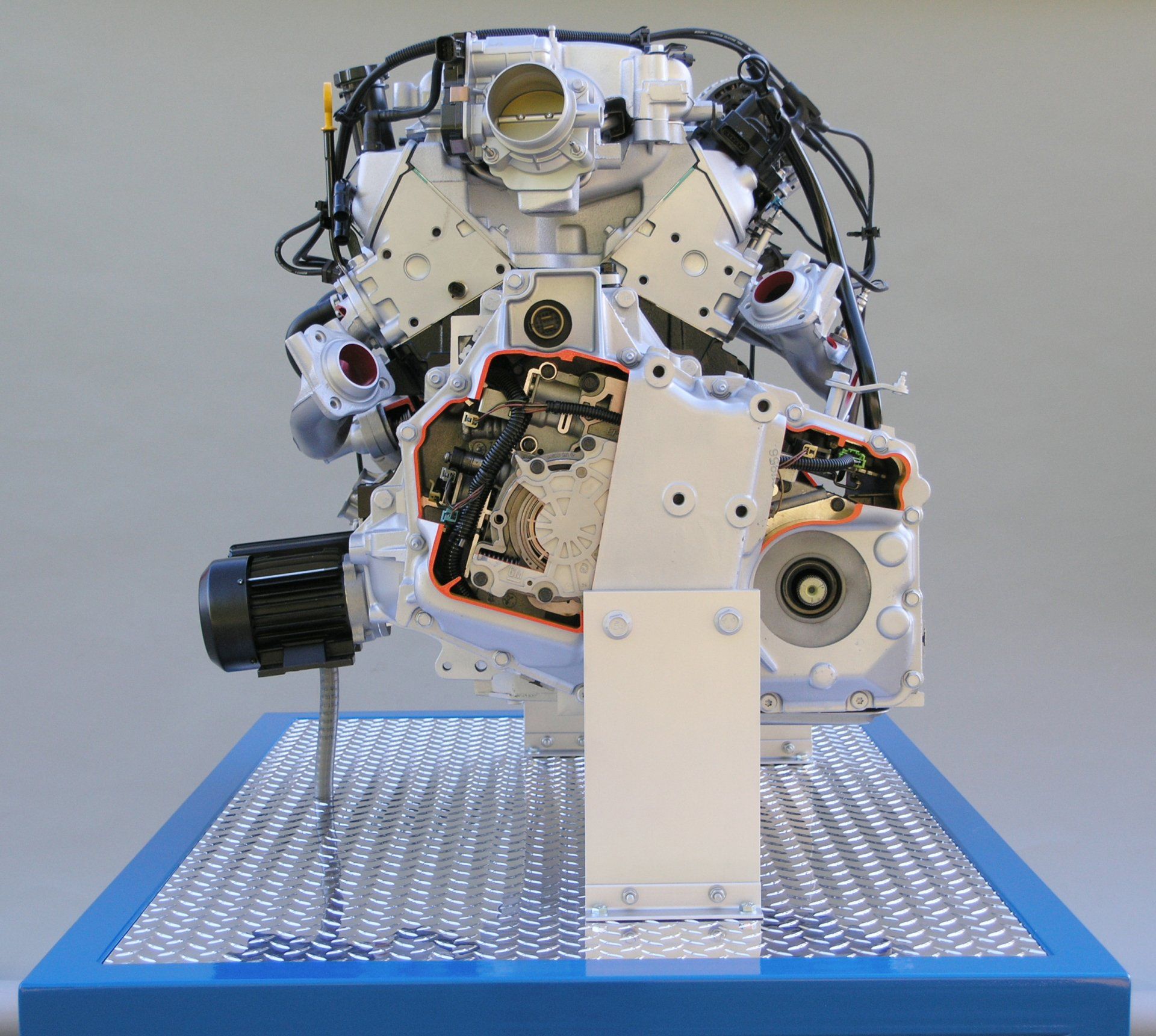 A model of a car engine on a blue table