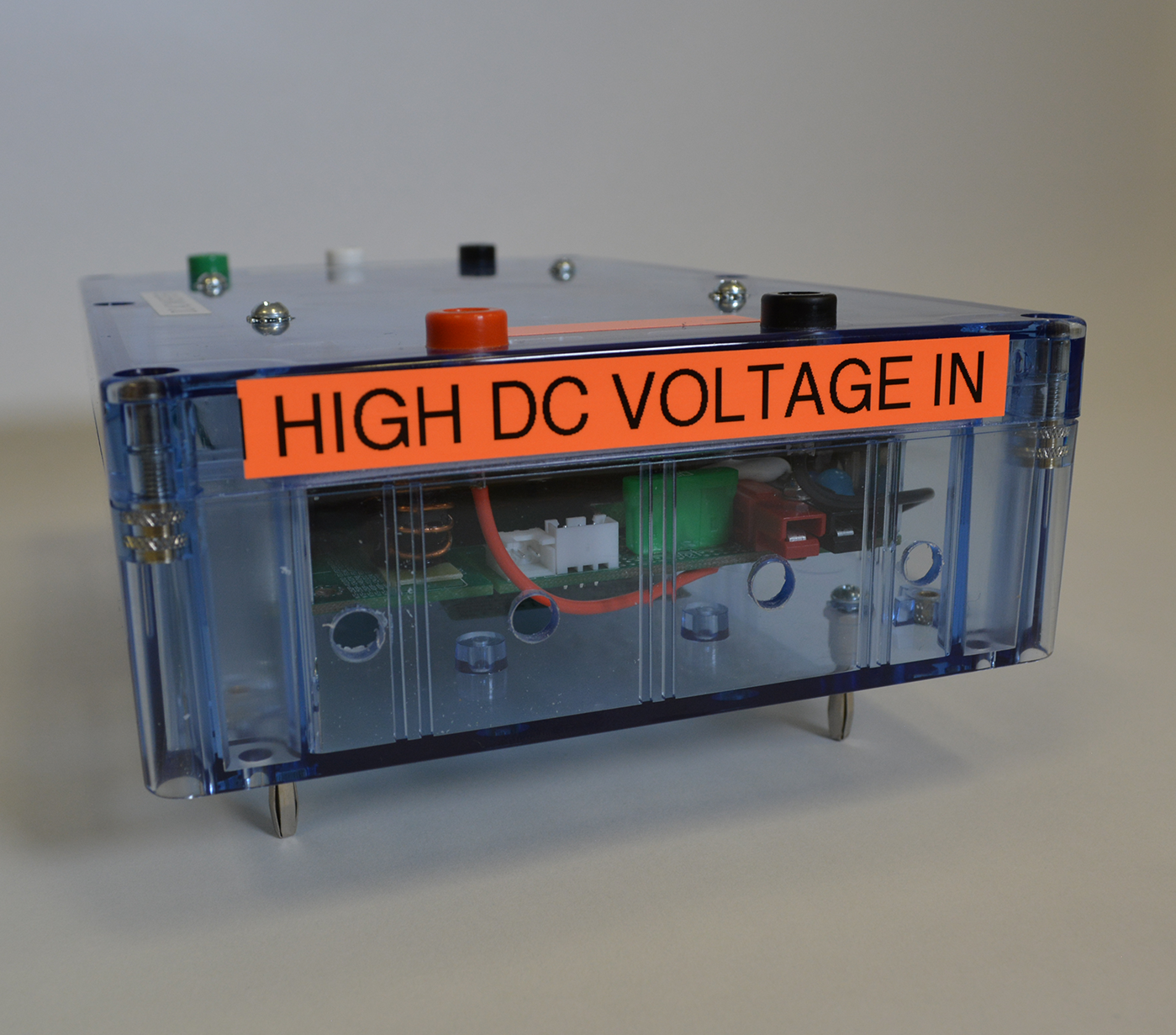 A clear box with a label that says high dc voltage in