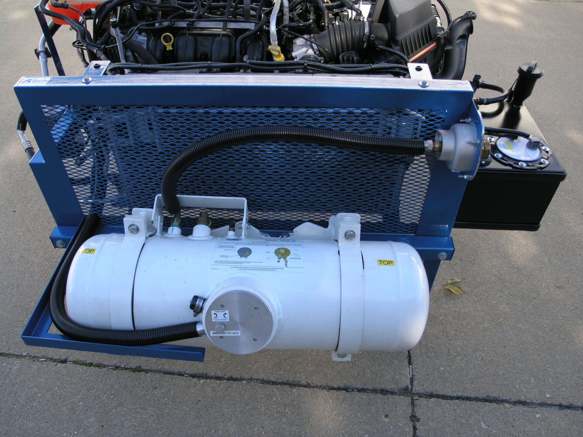 A propane tank with a hose attached to it