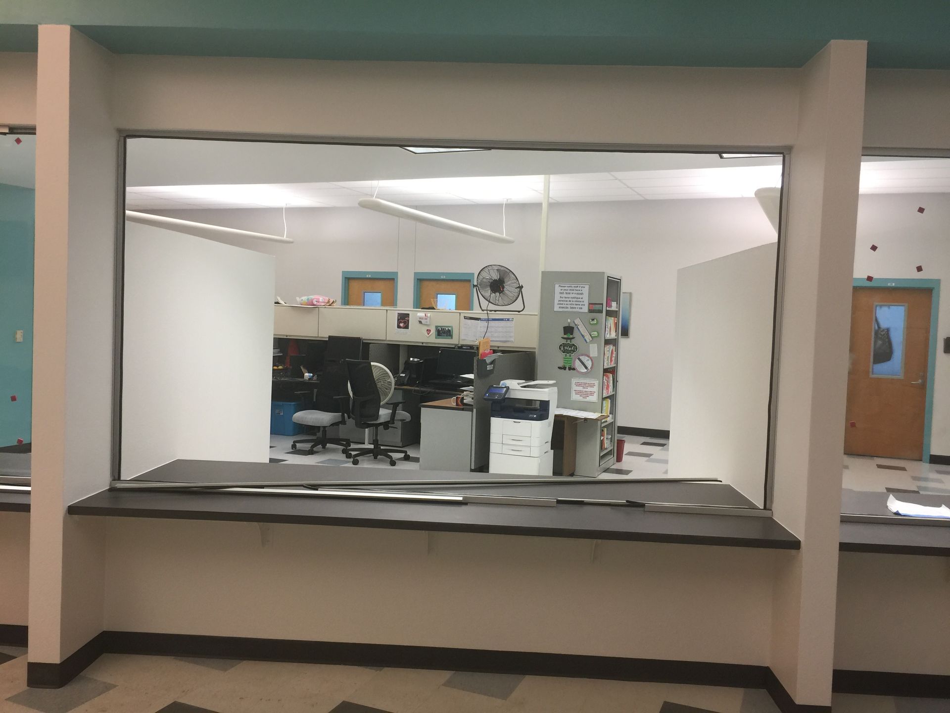 A man is standing in a room with a large window.