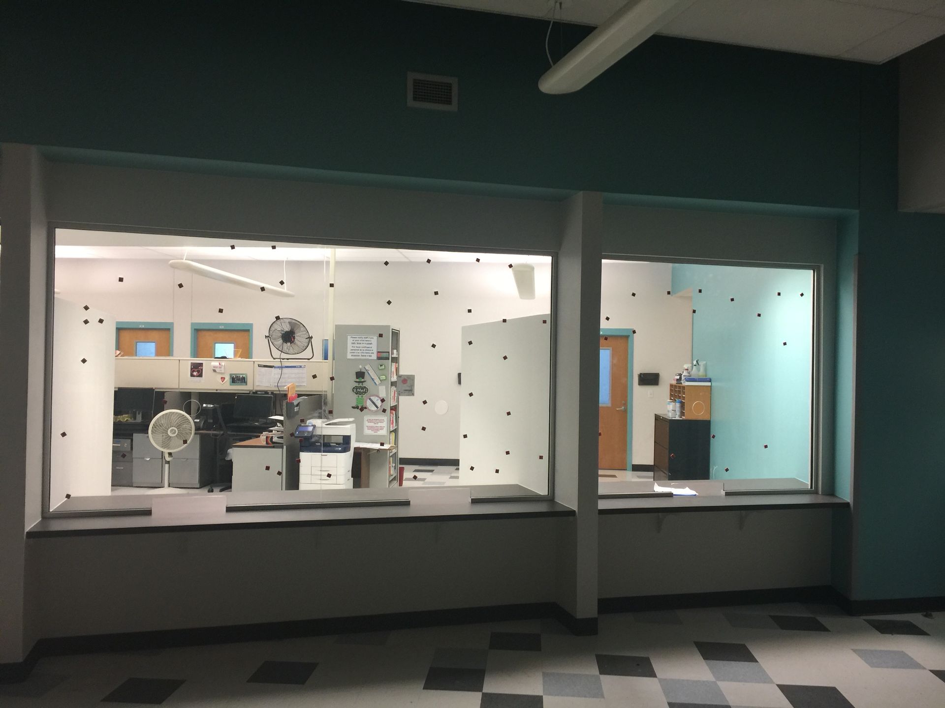 A room with a lot of windows and a checkered floor