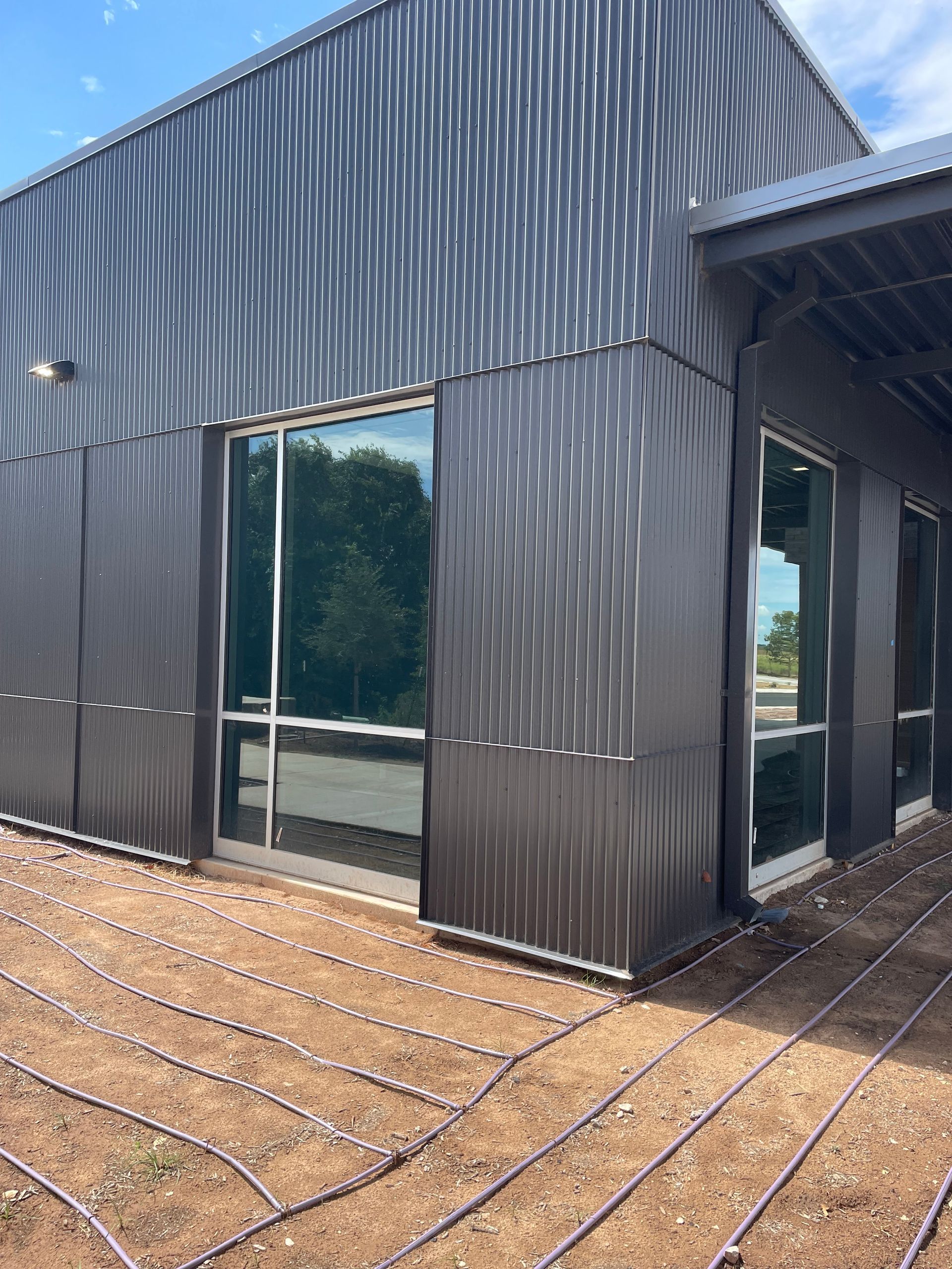 A large building with a lot of windows and a lot of drainage pipes.