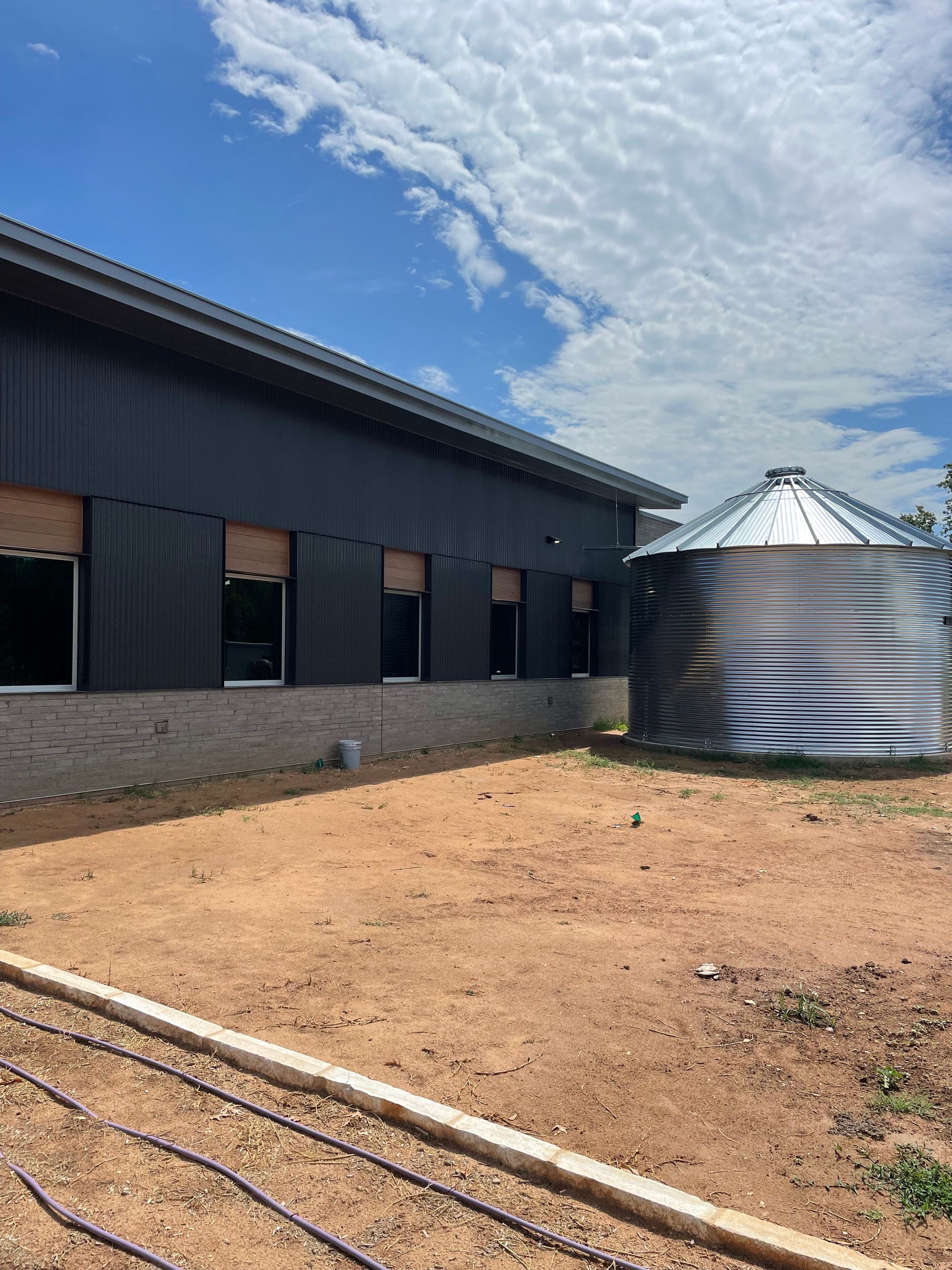 A large building with a silo in front of it.