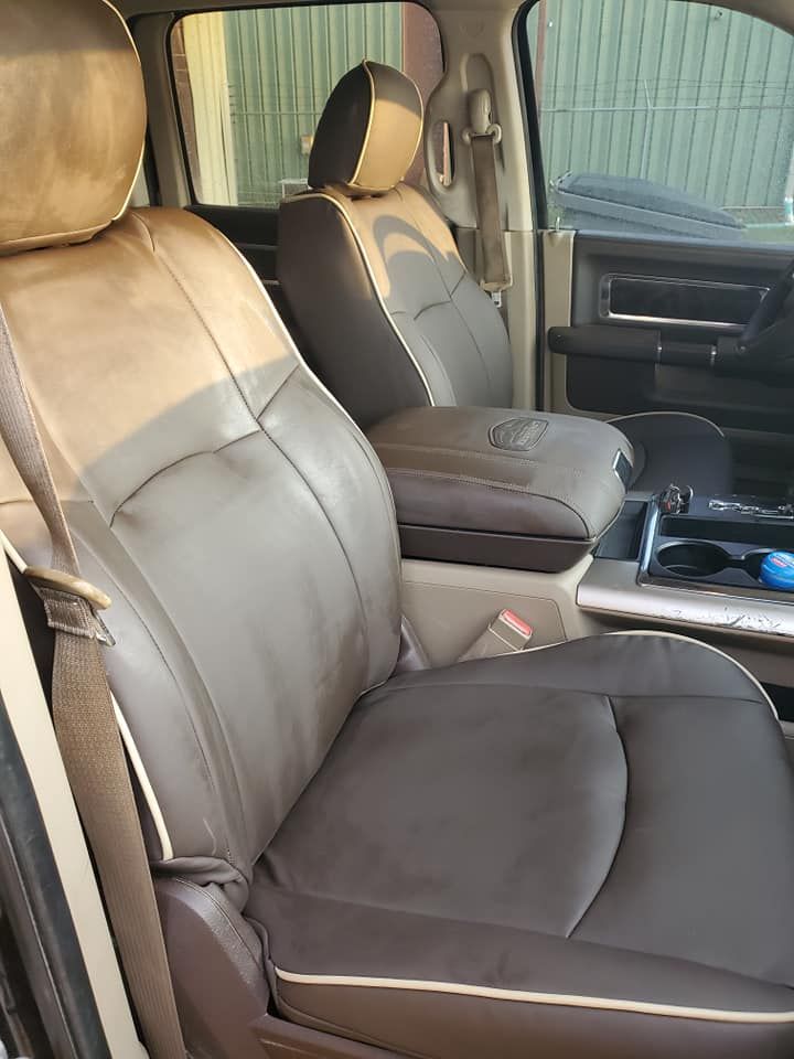 Dark brown and tan leather truck seats with center console.