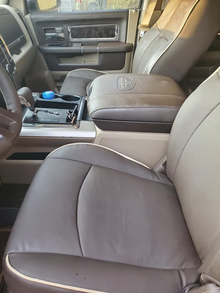 Tan and brown leather interior of a truck with center console and seats.