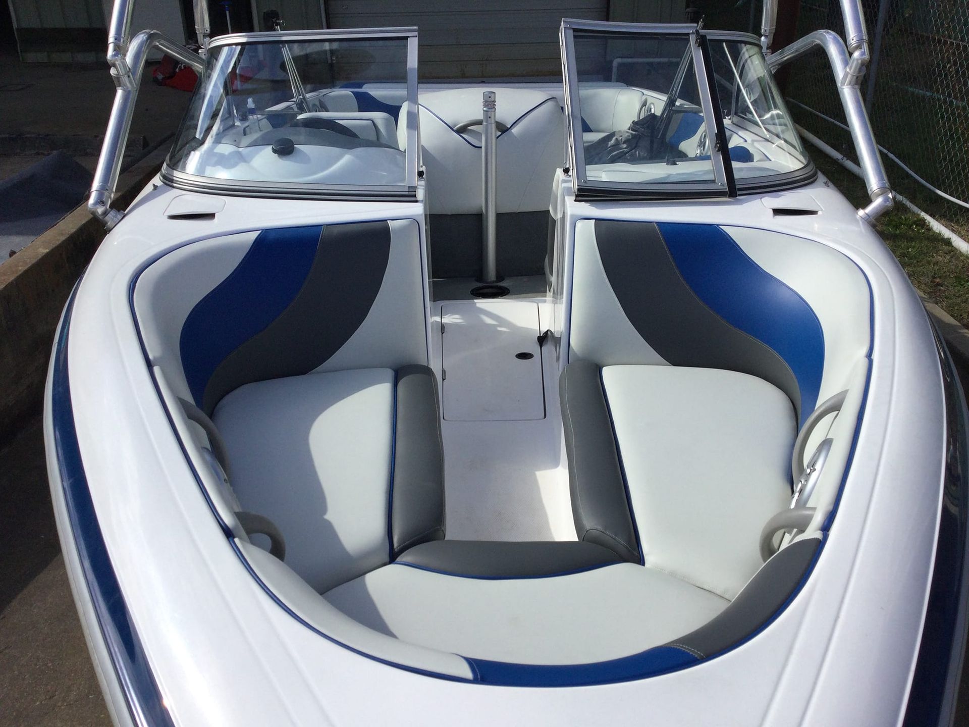 White boat interior with blue and gray seating.