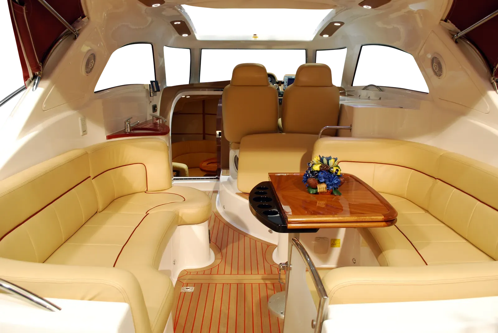 Beige leather car backseats with gray center panels; a window and blurry road are visible.