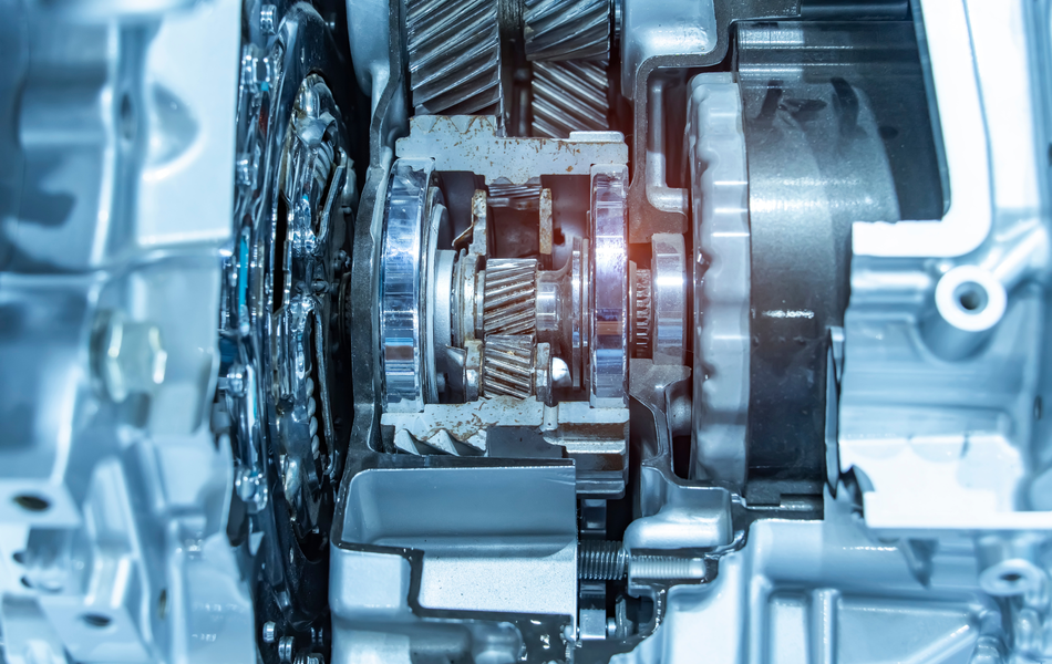 Cutaway view of an automotive transmission, showcasing gears and mechanical components in a silver housing.