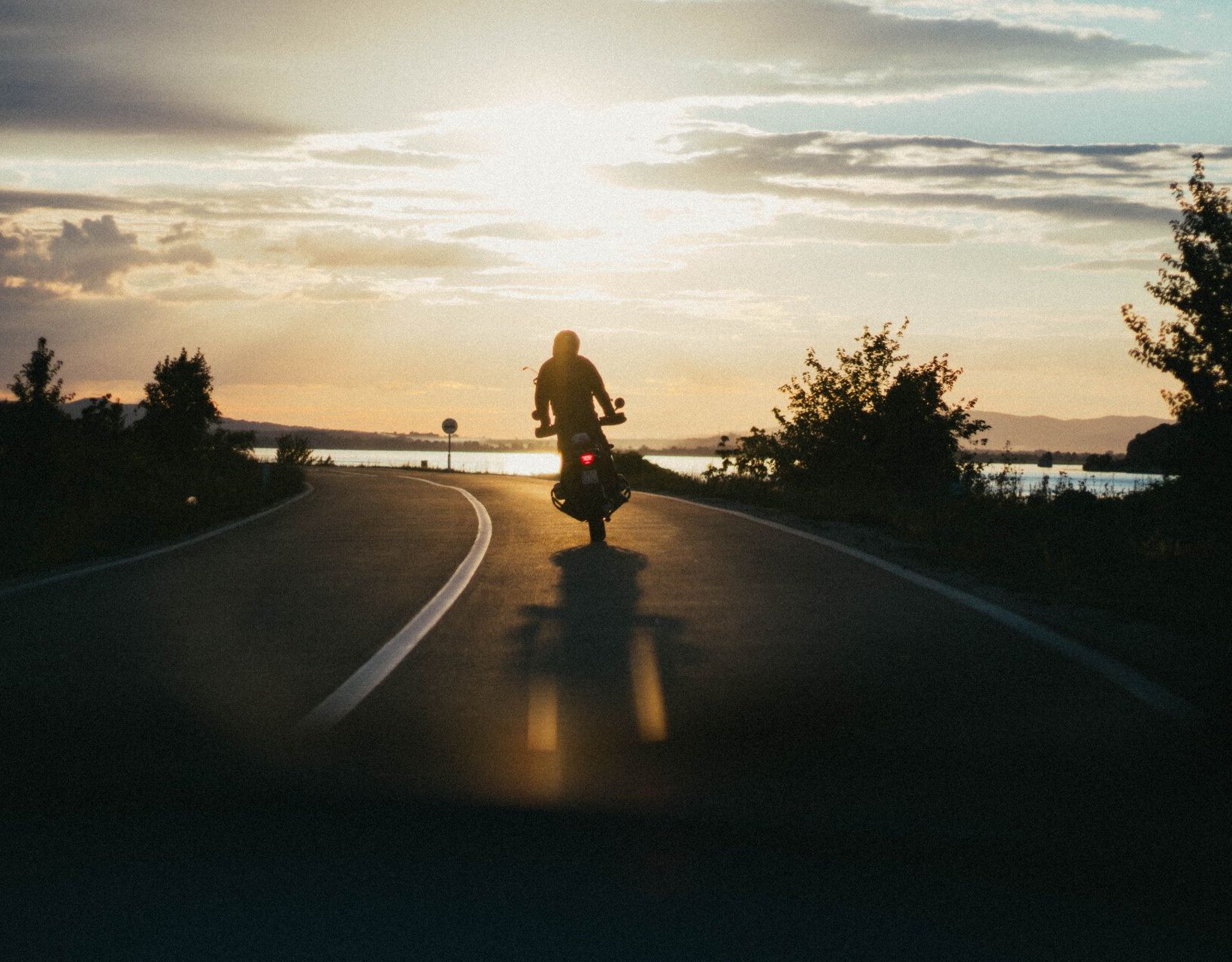 Man Riding Motorcycle at Twilight