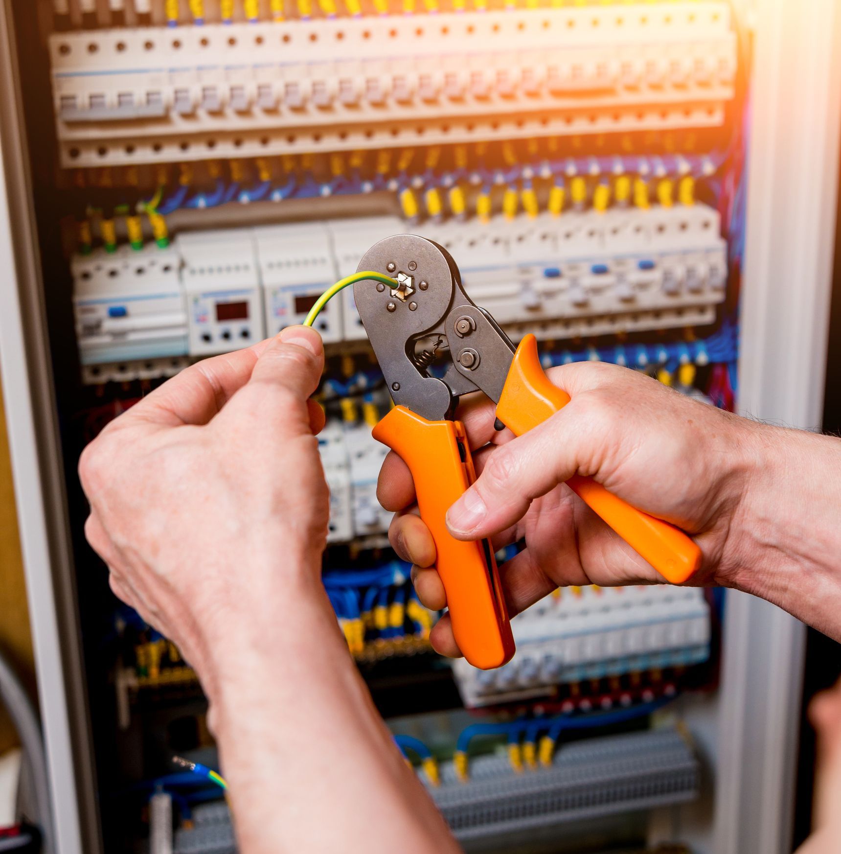 A technician from Conway Electric at the client's house working on emergency electrical repair