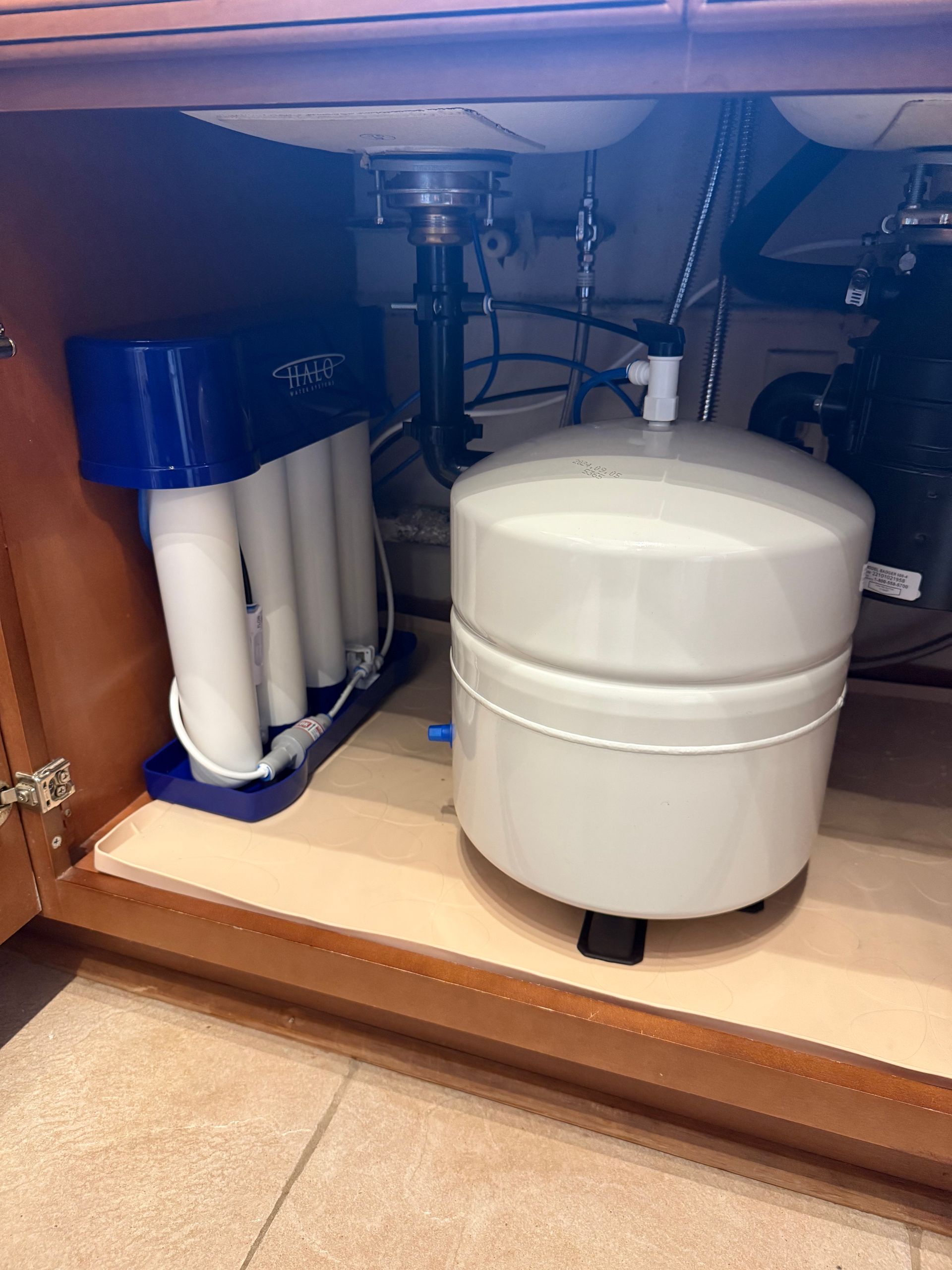 Air conditioning units with toolbox and gloves in backyard.