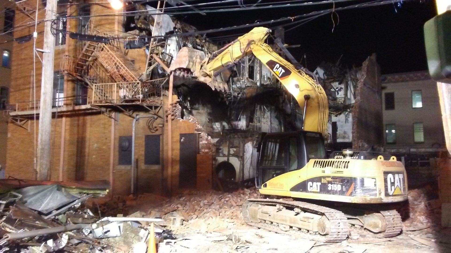 Tearing down an old building with a CAT excavator