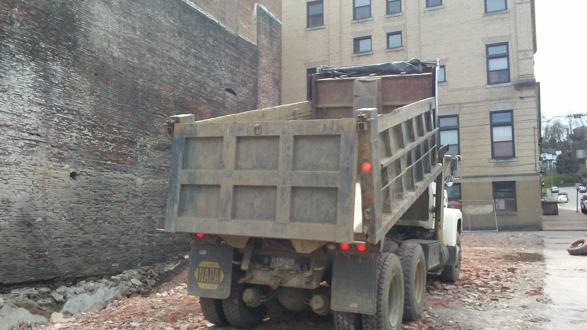 building demolished by schaaf with dump truck sitting where it used to be