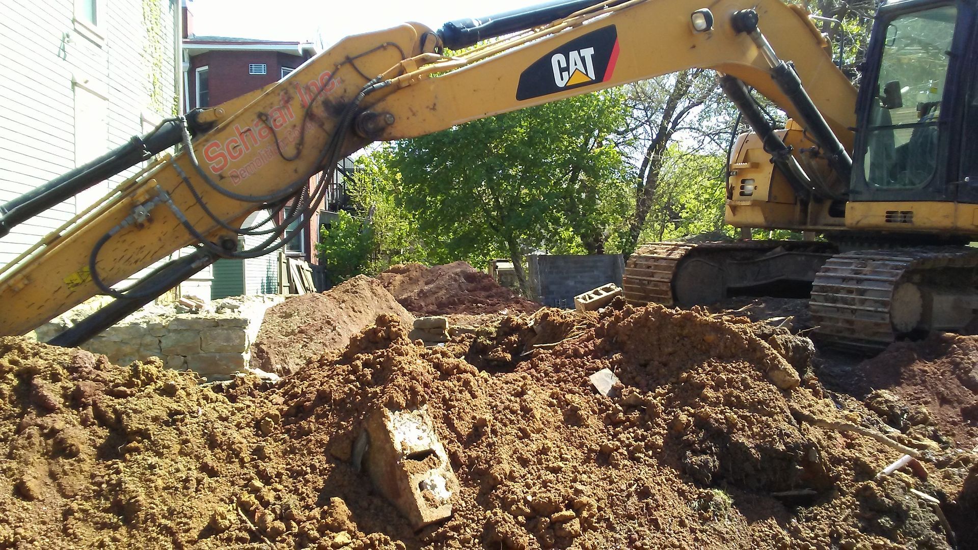 excavator filling in an old foundation