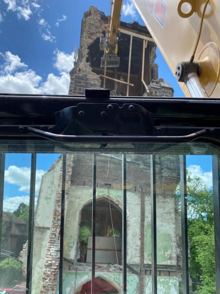 old church being demolished viewed from inside an excavator