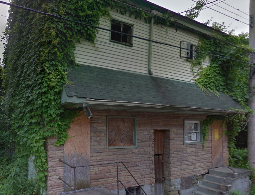 house with boarded up windows ready to be demolished