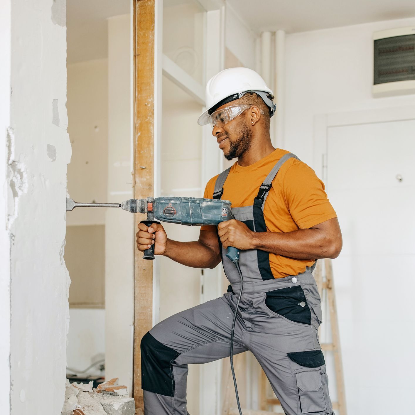 man demoing building wall