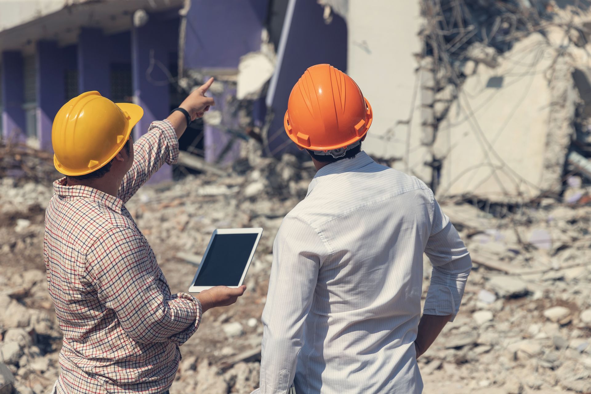 Contractors looking at a building during emergency demolition