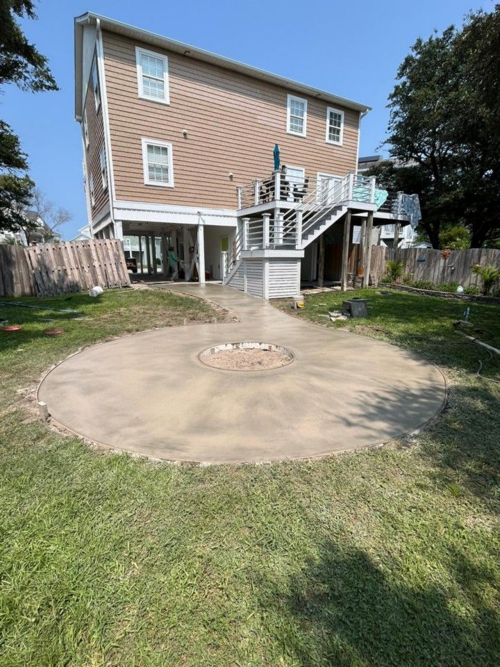 A large house with a fire pit in the backyard.