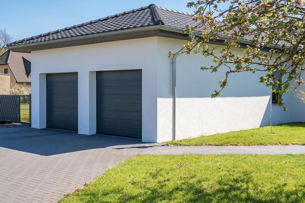 Modern And Luxurious Double Garage With Driveway And Roller Door — Roller & Garage Doors in Mackay, QLD