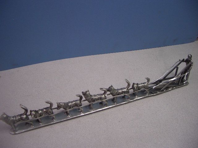 a statue of a man pulling a sled with dogs