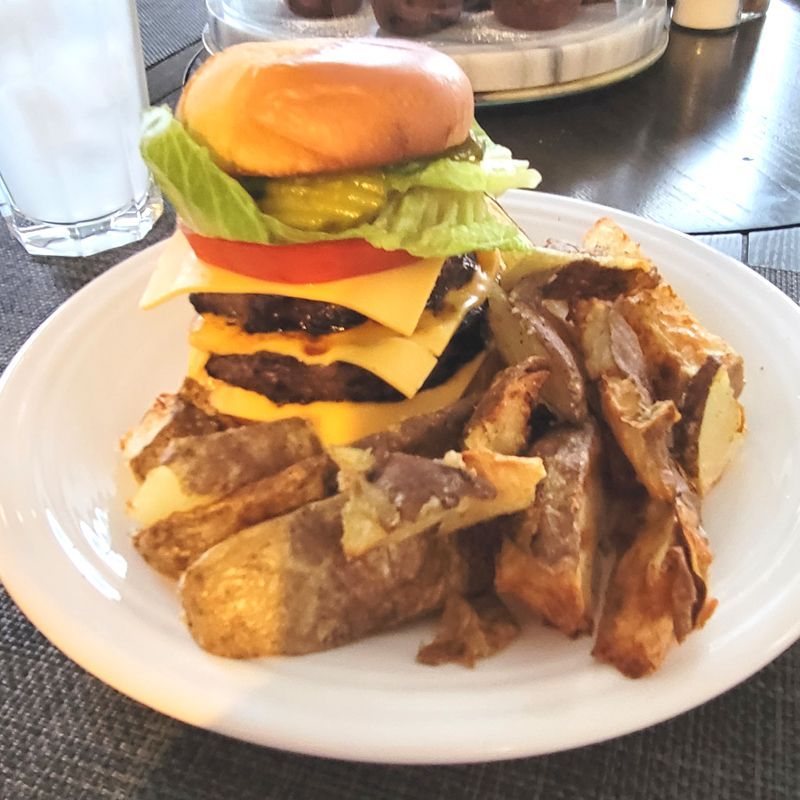 A white plate topped with a hamburger and french fries