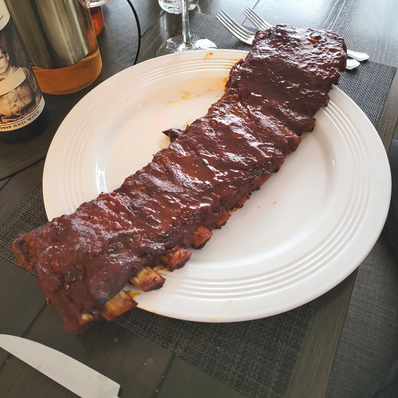 A white plate with a rack of ribs on it