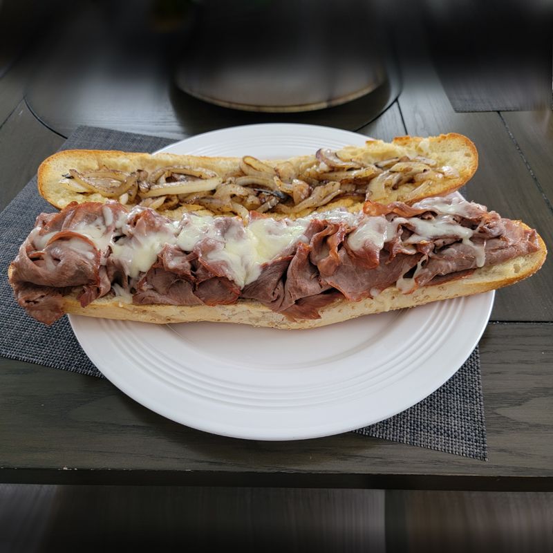 A sub sandwich on a white plate on a table